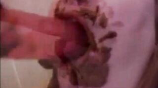 Dirty girl sucking and licking a shitty dildo