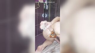 Pale skinny woman introduces a big dildo into her ass and shits