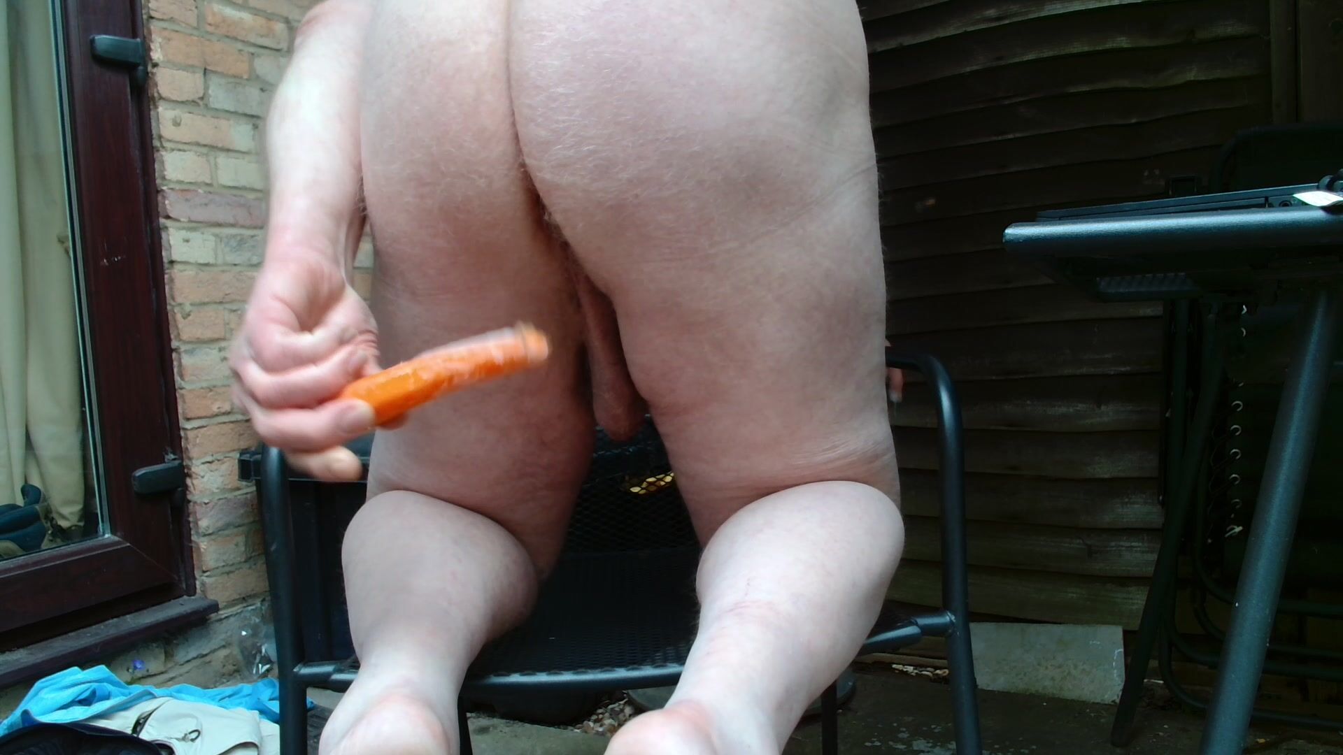 Me playing naked in my garden with a carrot in my ass Pervert Tube image